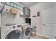 Bright laundry room features washer, dryer, storage cabinets, and shelving at 4714 Dail Rd, Lakeland, FL 33813