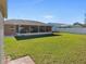 Backyard with screened porch and grassy area at 3189 Winchester Estates Loop, Lakeland, FL 33810