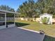 Grass backyard with shed and patio at 3189 Winchester Estates Loop, Lakeland, FL 33810