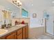 Clean bathroom with double sinks, a bathtub, and a shower at 3189 Winchester Estates Loop, Lakeland, FL 33810