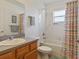Bathroom with a shower/tub combo and colorful shower curtain at 3189 Winchester Estates Loop, Lakeland, FL 33810