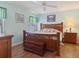 Main bedroom with a wooden bed frame and light wood floors at 3189 Winchester Estates Loop, Lakeland, FL 33810