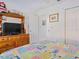 Bedroom with a TV stand and multicolored bedspread at 3189 Winchester Estates Loop, Lakeland, FL 33810