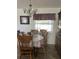 Bright dining room features a wood table with chairs and a chandelier at 3189 Winchester Estates Loop, Lakeland, FL 33810