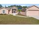 Tan house with solar panels, screened porch, and two-car garage at 3189 Winchester Estates Loop, Lakeland, FL 33810