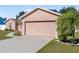 Attached garage with driveway and landscaping at 3189 Winchester Estates Loop, Lakeland, FL 33810