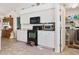 Kitchen with white cabinets, black appliances, and adjacent laundry at 3189 Winchester Estates Loop, Lakeland, FL 33810