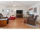 Living room with hardwood floors, fireplace, and comfortable seating at 3189 Winchester Estates Loop, Lakeland, FL 33810