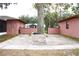 Brick-paved patio with a brick grill and surrounding trees at 2307 W Sugar Creek Dr, Lakeland, FL 33811