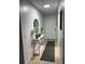 Clean and well-lit hallway with a console table and mirror at 401 Century Blvd # C, Auburndale, FL 33823