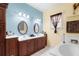 Bright bathroom with double vanity and a separate soaking tub at 587 Hunters Run Blvd, Lakeland, FL 33809