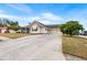 Two-car garage, driveway, and landscaped front yard at 587 Hunters Run Blvd, Lakeland, FL 33809