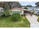 Single Gathering home with carport and well manicured lawn at 1724 Magnolia Ave, Lady Lake, FL 32159