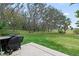 Spacious backyard with grassy area and grill at 1724 Magnolia Ave, Lady Lake, FL 32159