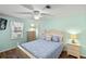 Guest bedroom with ceiling fan, wood floors, and light blue walls at 1724 Magnolia Ave, Lady Lake, FL 32159