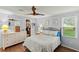 Main bedroom with ceiling fan, wood floors, and walk-in closet at 1724 Magnolia Ave, Lady Lake, FL 32159