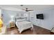 Guest bedroom with ceiling fan, wood floors, and ample natural light at 1724 Magnolia Ave, Lady Lake, FL 32159