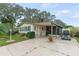 Single-story home with carport, golf cart, and landscaped yard at 1724 Magnolia Ave, Lady Lake, FL 32159