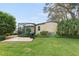 Well-maintained home with grassy lawn and screened patio at 1724 Magnolia Ave, Lady Lake, FL 32159