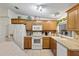 Well-equipped kitchen, white appliances, and oak cabinetry at 1724 Magnolia Ave, Lady Lake, FL 32159