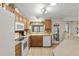 View of kitchen with oak cabinets, white appliances, and a door to outside at 1724 Magnolia Ave, Lady Lake, FL 32159