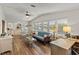 Bright living room featuring a comfortable sofa and wood floors at 1724 Magnolia Ave, Lady Lake, FL 32159