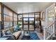 Bright screened porch with comfy seating and a cat tree at 1724 Magnolia Ave, Lady Lake, FL 32159