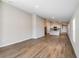 Bright living room with wood flooring and an open layout that leads to the kitchen at 6230 Sw 96Th Pl, Ocala, FL 34476