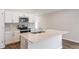 Bright kitchen features white cabinetry, stainless steel appliances, and a center island at 6244 Sw 96Th Pl, Ocala, FL 34476