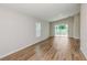 Bright living room with wood-look floors, neutral walls and access to the backyard at 6244 Sw 96Th Pl, Ocala, FL 34476