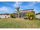 Spacious backyard with lush landscaping and a screened pool at 8710 Hinsdale Heights Dr, Polk City, FL 33868