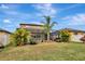 Landscaped backyard oasis with a large, screened-in pool at 8710 Hinsdale Heights Dr, Polk City, FL 33868