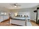 Main bedroom with wood floors, shiplap wall, and ensuite bathroom at 8710 Hinsdale Heights Dr, Polk City, FL 33868
