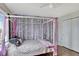 Serene bedroom with a canopy bed and nature-inspired wall art at 8710 Hinsdale Heights Dr, Polk City, FL 33868