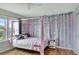 Bright bedroom featuring a canopy bed and leafy wall decor at 8710 Hinsdale Heights Dr, Polk City, FL 33868
