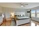 Main bedroom with wood floors, white bed frame, and shiplap wall at 8710 Hinsdale Heights Dr, Polk City, FL 33868