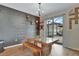 Bright dining room features a rustic table with bench seating, and sliding glass doors to backyard at 8710 Hinsdale Heights Dr, Polk City, FL 33868