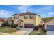 Two-story house with brown accents and a two-car garage at 8710 Hinsdale Heights Dr, Polk City, FL 33868