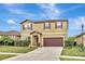 Two-story house with brown accents and a landscaped lawn at 8710 Hinsdale Heights Dr, Polk City, FL 33868