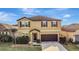 Two-story house with brown accents and a two-car garage at 8710 Hinsdale Heights Dr, Polk City, FL 33868