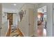 Upstairs hallway with barn door, hardwood floors, and bedroom access at 8710 Hinsdale Heights Dr, Polk City, FL 33868