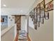 Upstairs hallway with barn door, hardwood floors, and photo wall at 8710 Hinsdale Heights Dr, Polk City, FL 33868