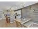 Modern kitchen boasts white cabinets, granite countertops, and an island with seating at 8710 Hinsdale Heights Dr, Polk City, FL 33868