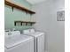 Laundry room featuring Samsung washer and dryer and wood shelving at 8710 Hinsdale Heights Dr, Polk City, FL 33868