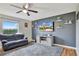 Relaxing living room featuring a large TV and accent wall at 8710 Hinsdale Heights Dr, Polk City, FL 33868