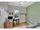 Home office with large desk, two monitors, and plenty of natural light at 8710 Hinsdale Heights Dr, Polk City, FL 33868