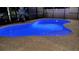 Inviting kidney-shaped pool with blue lighting at night at 8710 Hinsdale Heights Dr, Polk City, FL 33868