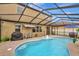 Inviting screened-in pool with grill and patio furniture at 8710 Hinsdale Heights Dr, Polk City, FL 33868