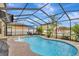 Relaxing screened pool with patio furniture and lush landscaping at 8710 Hinsdale Heights Dr, Polk City, FL 33868