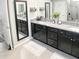 Double vanity bathroom with granite countertops and ample storage at 5450 Sunshine Dr, Wildwood, FL 34785